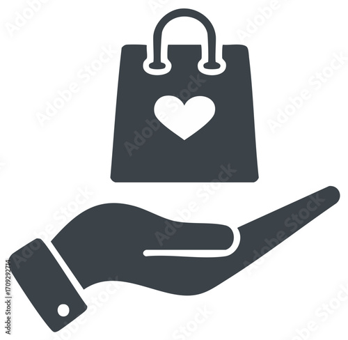 Hand holding shopping bag with heart symbol, representing a gift or charity.