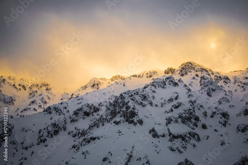 Golden Light on Snowy Peaks – Dramatic Mountain Landscape at Sunrise