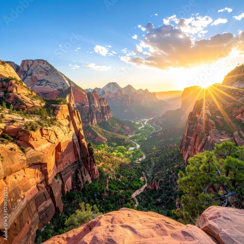 Majestic canyon vista showcases sunburst through clouds over rocky landscape with layers of mountains, greenery, and colorful sandstone