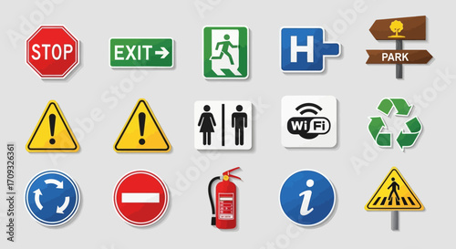 Flat lay image of various colorful informational and warning signs against a neutral gray background, showcasing a diverse collection of symbols including stop, exit,