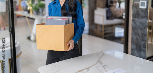 Photos Quit Job asian business woman sending resignation letter and packing Stuff Resign Depress or carrying business cardboard box in office