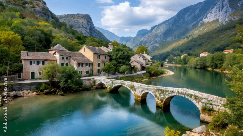 Fototapeta premium Beautiful landscape with an old stone bridge featuring traditional houses and mountains