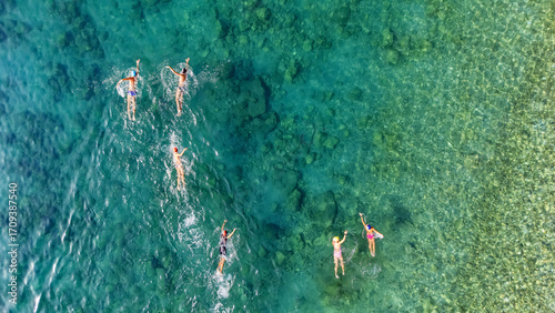 Fotografie Aerial drone view of people swimming in turquoise sea, group of swimmers trainin