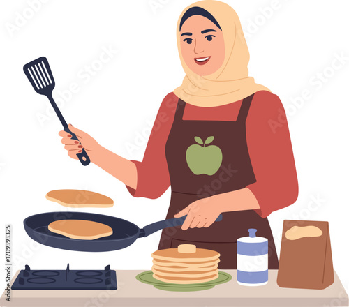 Woman cooking pancakes in kitchen wearing hijab apron