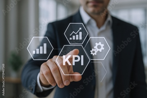 Businessman Analyzing Key Performance Indicators (KPIs) on a Digital Interface for Business Growth and Success © The Little Hut