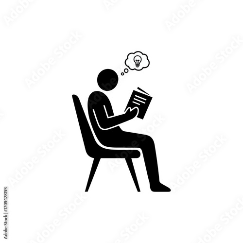 Businessman working on laptop while sitting on a chair in an office setting