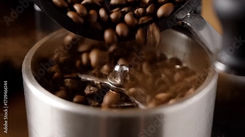 Fresh coffee beans cascade into grinder, promising rich aroma and energizing brew.
