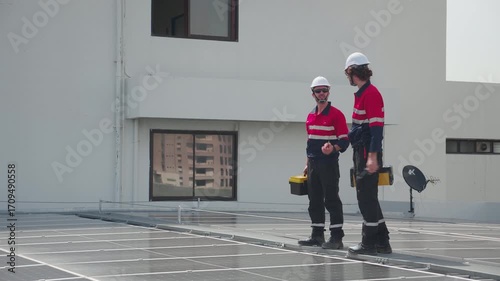Team engineer and technician working on solar panel installation at rooftop, renewable energy inspection with teamwork, clean power technology for sustainable electricity, industry and solar cell.