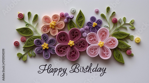 Handmade Quilling Paper Card. An intricate card decorated with finely rolled paper shapes forming flowers and 