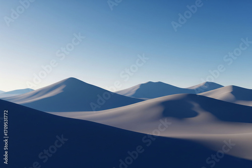 A serene landscape featuring soft, blue-toned desert dunes under a clear, pale sky. The image evokes a sense of minimalist beauty, with gentle shadows creating depth.