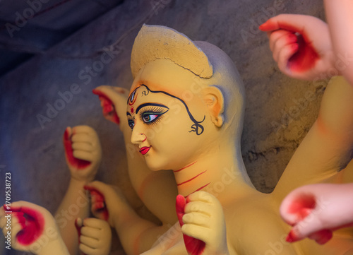 Close up of a painted face of Hindu Goddess Durga. Selective focus