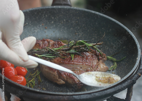 Pan-fried steak with red tomatoes and rosemary