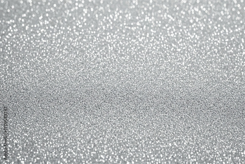Closeup macro shot of sparkling silver glitter, creating a festive and celebratory background with a shallow depth of field