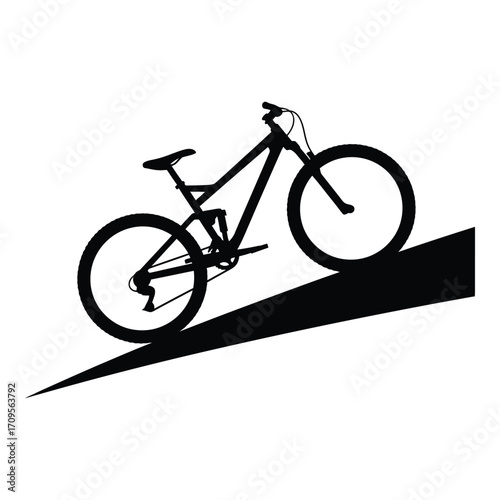 Silhouette of a mountain bike riding downhill on a steep incline silhouette