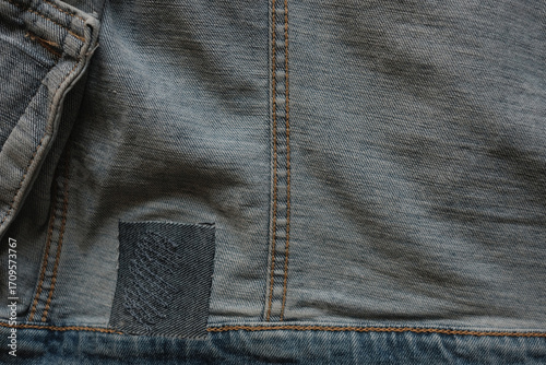 closeup detail of a repaired denim jacket