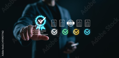 Obraz na płótnie Businessman selecting quality assurance certification icon on virtual screen