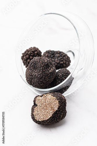 Wallpaper Mural Black truffle mushrooms on the white background. Fragrance of black truffle mushrooms. Autumn gourmet cuisine of Piedmont, Northern Italy, France, Spain  Torontodigital.ca