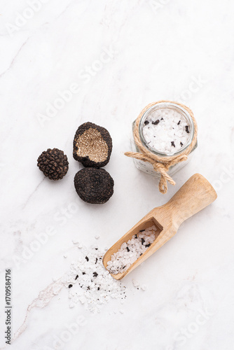 Wallpaper Mural Truffle salt and truffle on the white table, how to preserve the aroma and taste of black truffle. Preserving black truffle. Delicacy condiment for flavoring dishes, front view Torontodigital.ca