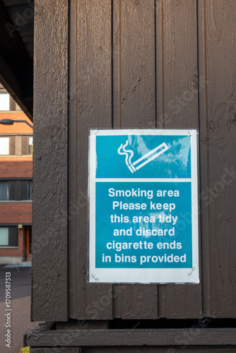 Smoking area sign attached on a wooden wall
