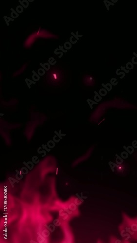Abstract pink fire with rising sparks creating a magical and energetic blaze on a completely black isolated backdrop