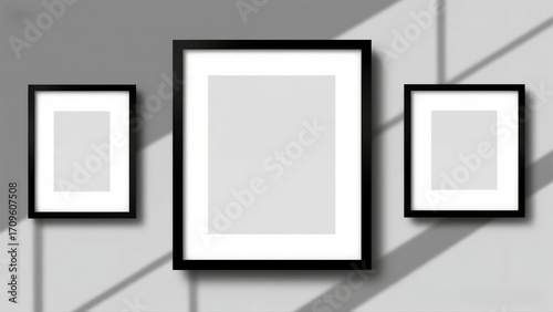 Blank frames on a wall with shadows