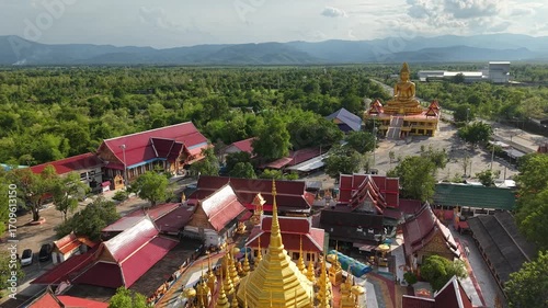 A large chedi temple surrounded by smaller golden chedis