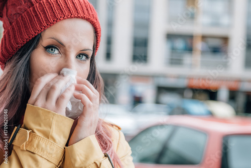 Young Woman Fighting a Cold While Walking Outside