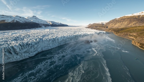 Wallpaper Mural Revealing glacier ice wall extending into deep blue lake, with floating ice chunks and snowy peaks Torontodigital.ca