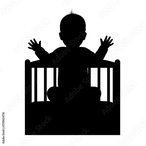 Silhouette of a happy baby sitting in a crib with arms raised in celebration