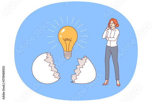 Business woman who has come up with new idea stands near light bulb that emerged from eggshell. Successful young girl corporate employee, developed idea for startup after brainstorming