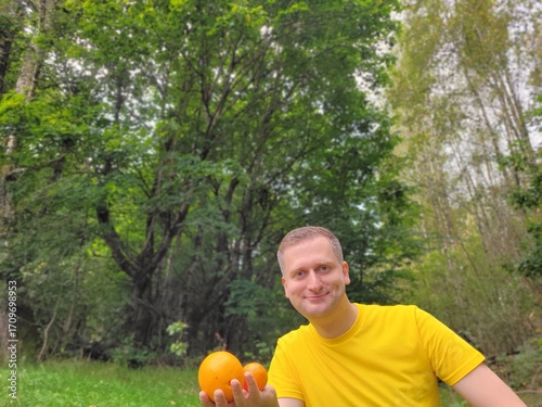 Nice man holding summer fruits