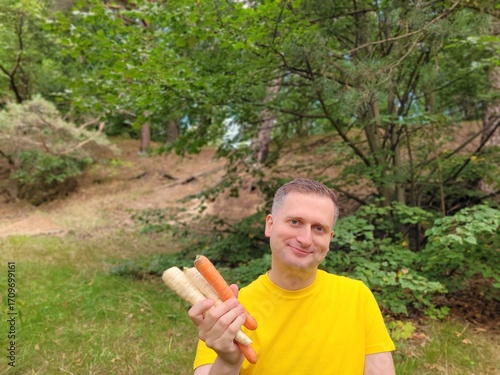 Nice man holding raw vegetables