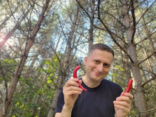Adult man holding spicy peppers