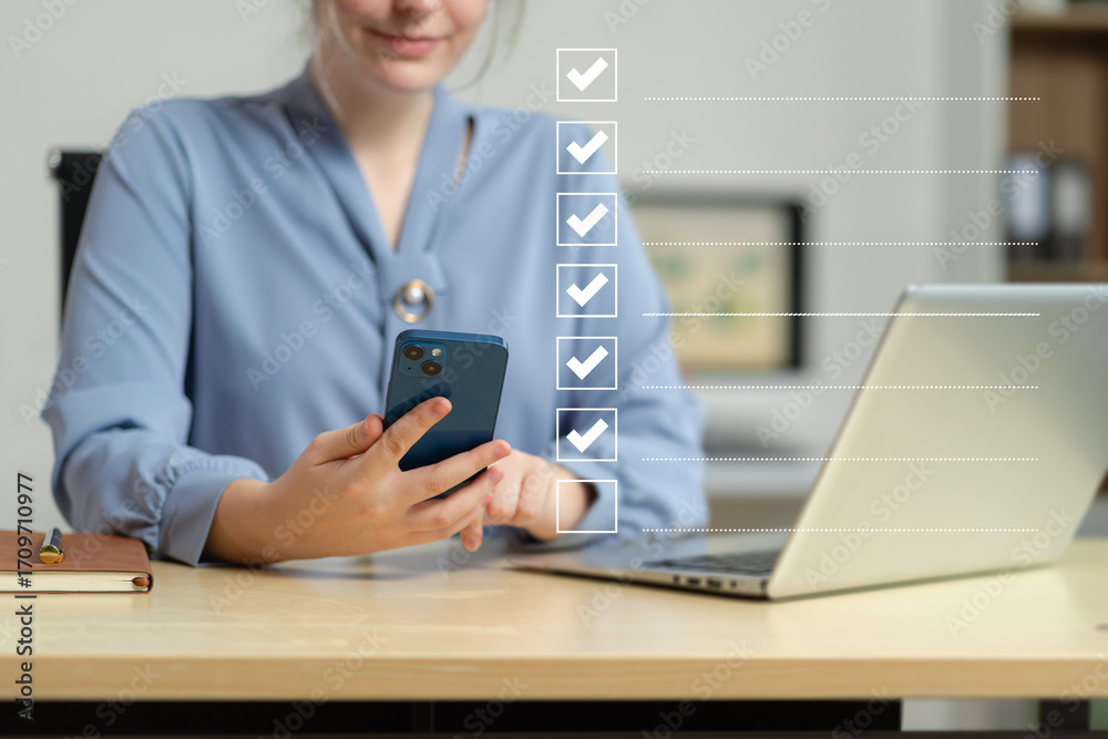 Fototapeta premium Business woman using tablet to do online checklist survey, doing assessment online survey answer test questions Digital form.