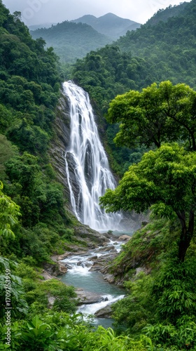 Majestic waterfall cascading through lush green forest in vietnam
