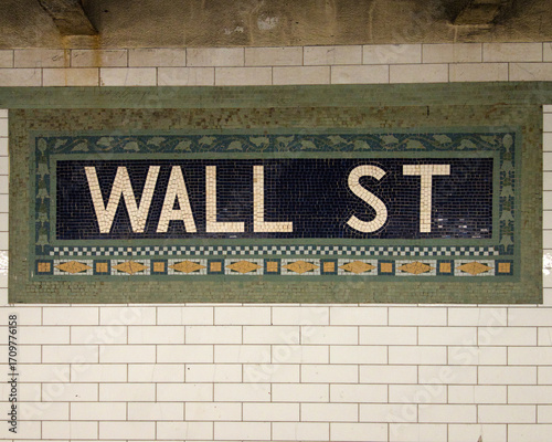 Wall Street Subway Sign - A tiled mosaic sign for the Wall Street subway station in New York City, a key financial district and historic urban landmark.