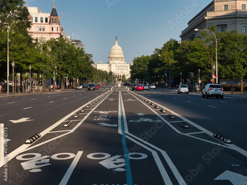 United States Capitol Building from the Street - The U.S. Capitol Building seen from a wide street with bike lanes and trees on a sunny day in Washington, D.C.
