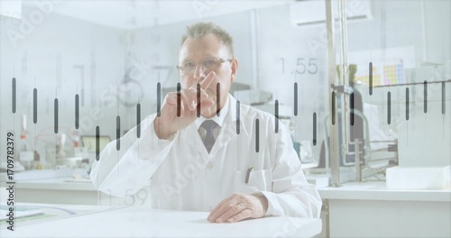 Analyzing virtual data overlay, senior scientist wearing lab coat at curved table in bright lab