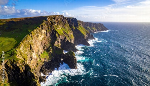Aerial view of a coastal cliff with waves crashing below