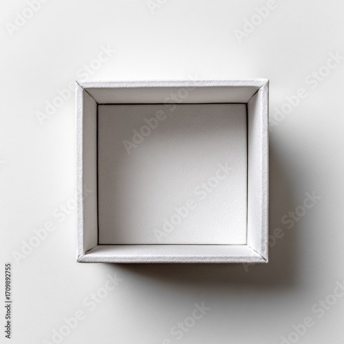 Empty white square box on a white surface