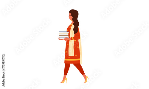 A young Indian woman in traditional attire walking from the side while carrying a stack of books.