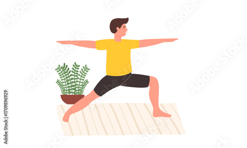 Man practicing yoga warrior II pose at home.