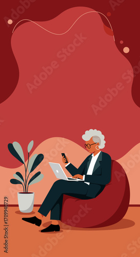 Confident senior businesswoman uses laptop and smartphone from a relaxed beanbag setting, embodying modern remote work and digital engagement.