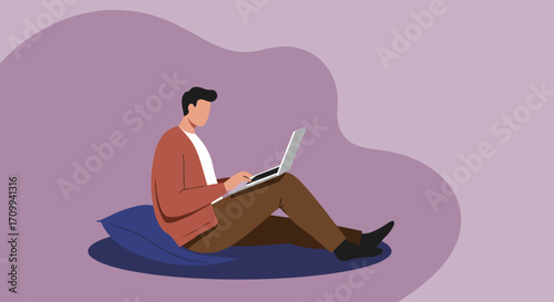 Relaxed senior man with a beard and glasses sits comfortably on a beanbag, focused on his laptop. Illustrates modern digital lifestyle and remote work for older adults.