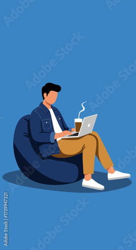 Young man works comfortably on a laptop from a beanbag, enjoying a hot drink. Ideal for remote work, online learning, or modern relaxed lifestyle concepts.