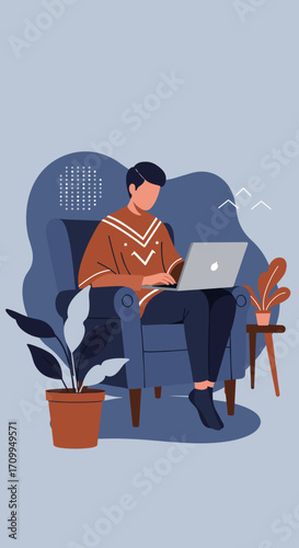 Young man working remotely on a laptop from a comfortable armchair at home, embodying flexible work and modern lifestyle.