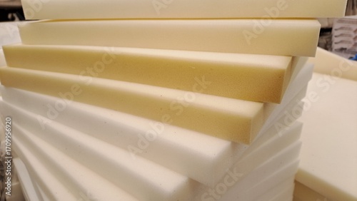 Φωτογραφία Stacked sheets of yellowed foam rubber for furniture production in factory works