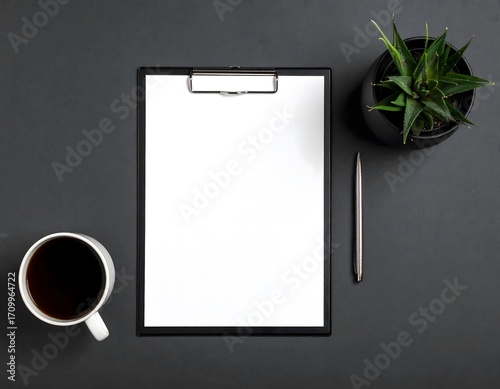 Top view of a minimalist dark office desk with a blank clipboard mockup, perfect for strategic business planning and creative ideas