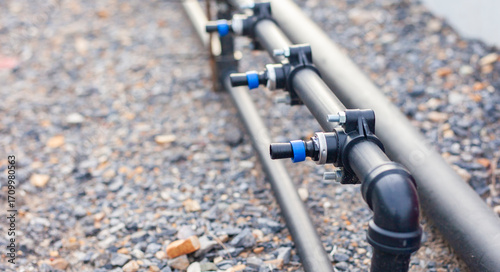 Close-up of an agricultural water management infrastructure system with pipes and valves. Modern agriculture. Maintenance of agricultural irrigation systems.
