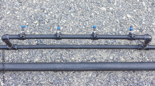 Close-up of a water pump. Agricultural water piping system. PVC pipe connectors.